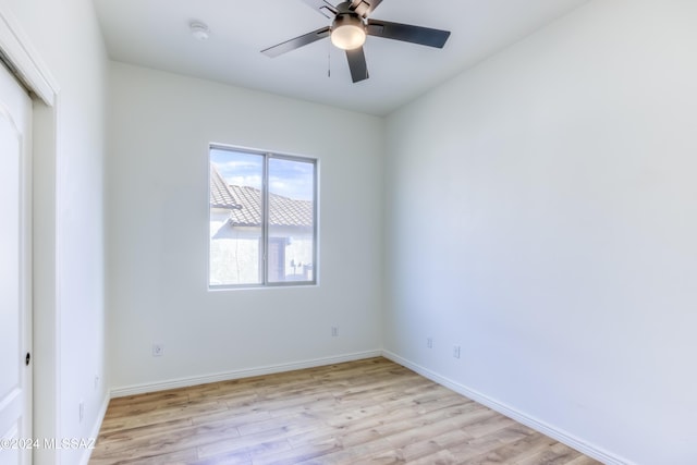 unfurnished room with light wood-type flooring and ceiling fan