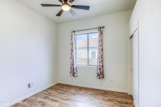 spare room with light hardwood / wood-style floors and ceiling fan