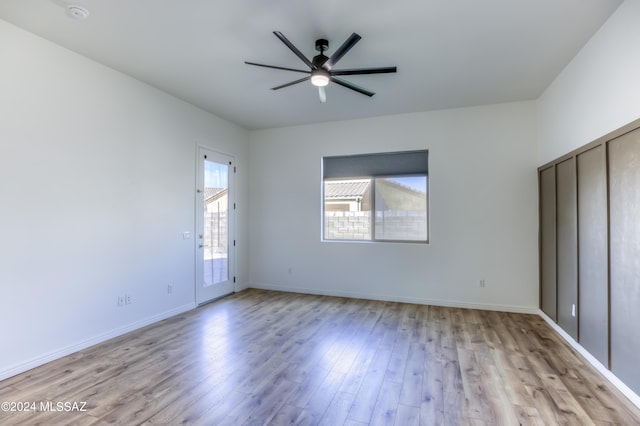 unfurnished bedroom with ceiling fan and light wood-type flooring