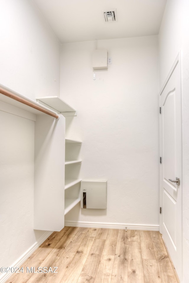 spacious closet featuring light hardwood / wood-style floors