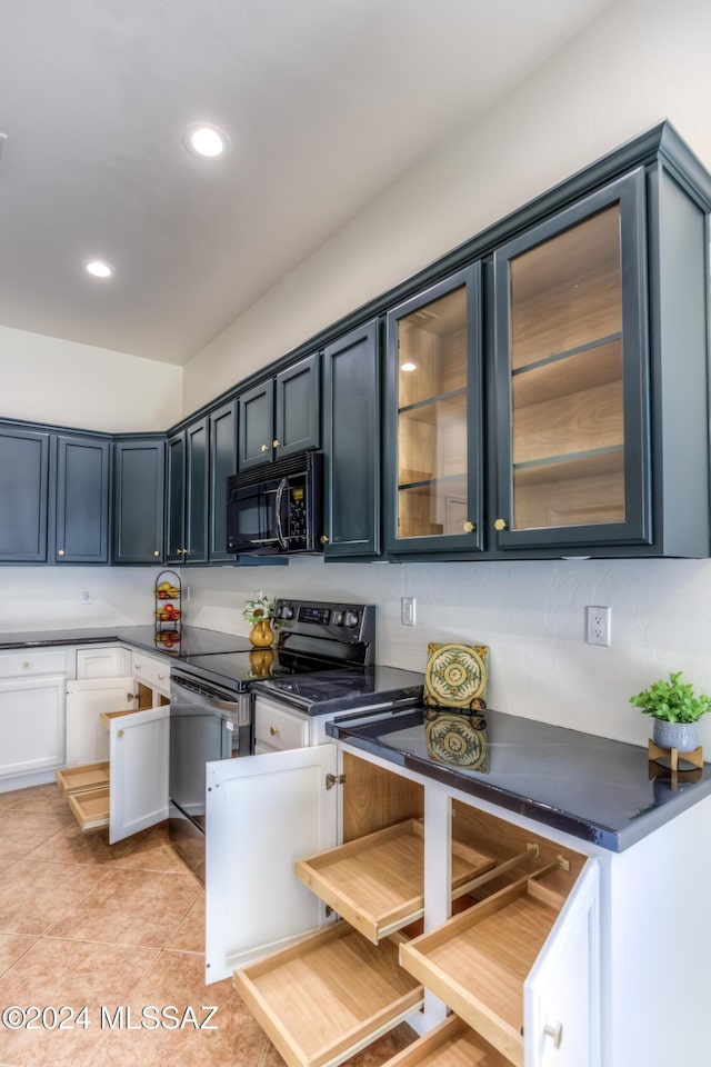 kitchen featuring light tile patterned flooring and black appliances