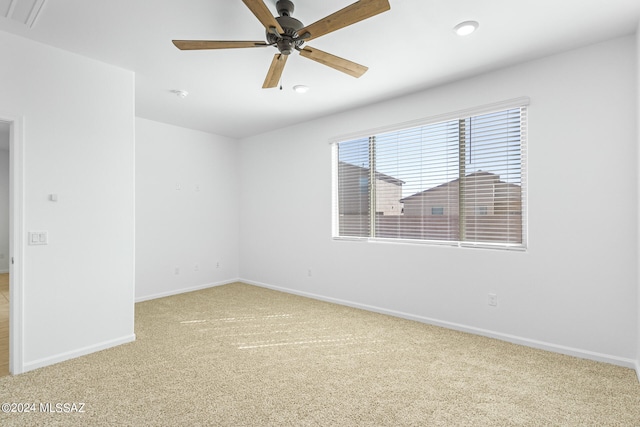 carpeted empty room featuring ceiling fan