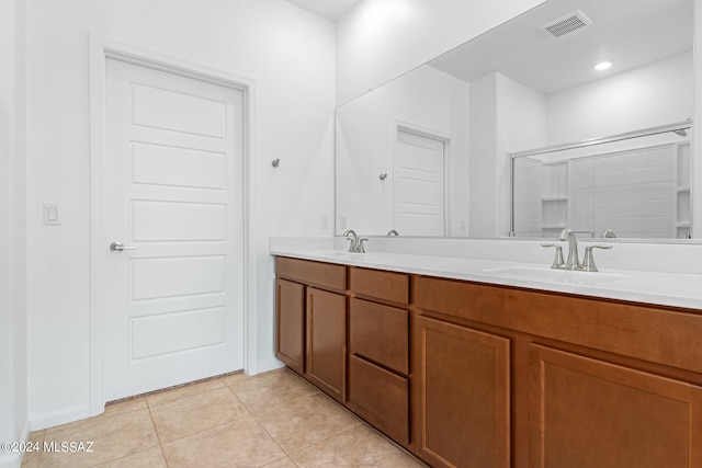 bathroom featuring tile patterned floors, vanity, and a shower with shower door