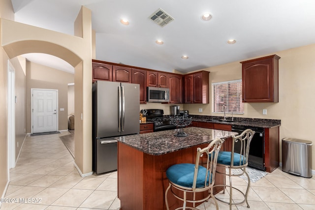 kitchen with a center island, black appliances, vaulted ceiling, and sink