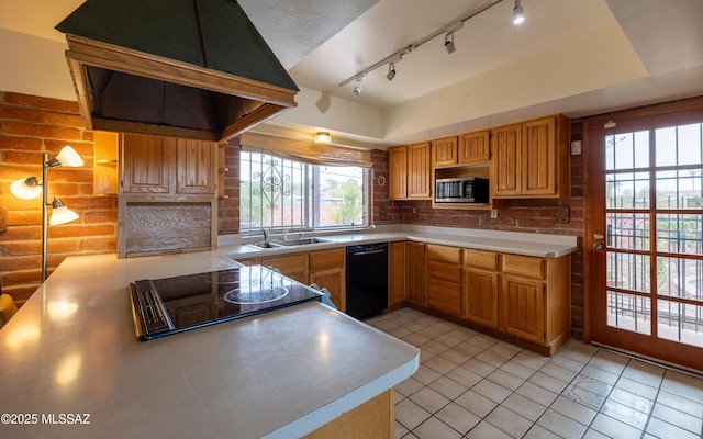 kitchen featuring a sink, stainless steel microwave, black dishwasher, stovetop, and light countertops