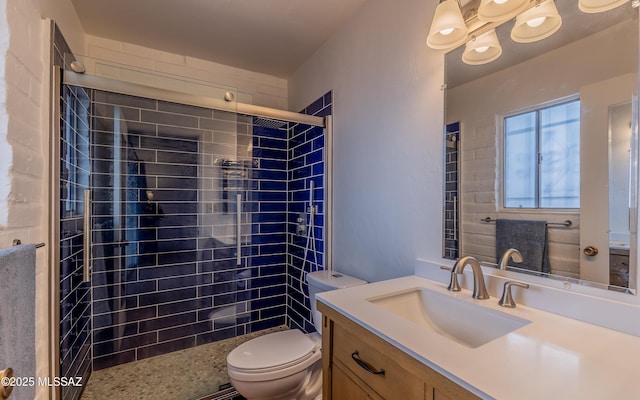 full bath featuring a tile shower, toilet, and vanity