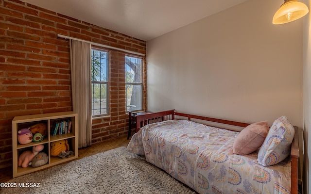 bedroom with brick wall