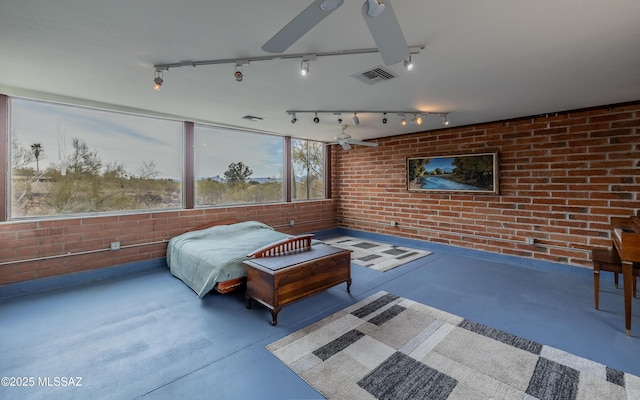 bedroom with visible vents, brick wall, and concrete floors