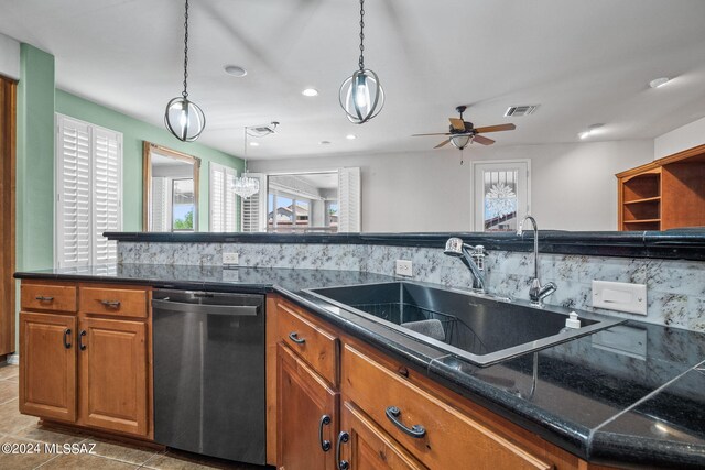 kitchen featuring stainless steel dishwasher, a sink, brown cabinetry, and a wealth of natural light