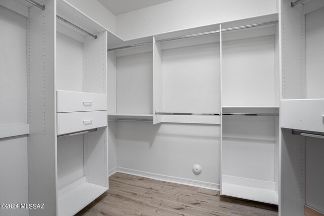 spacious closet with wood finished floors