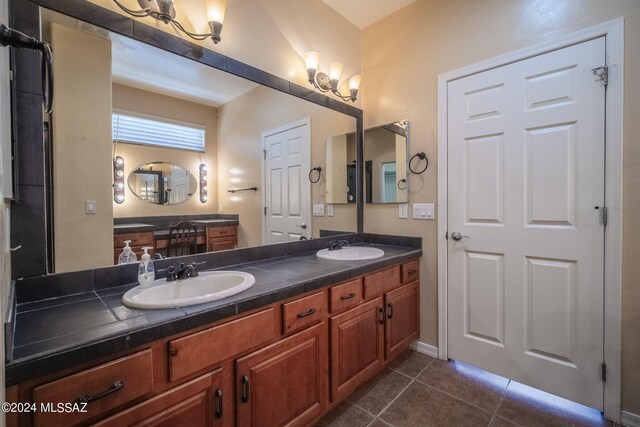 bathroom with a sink, tile patterned floors, and double vanity