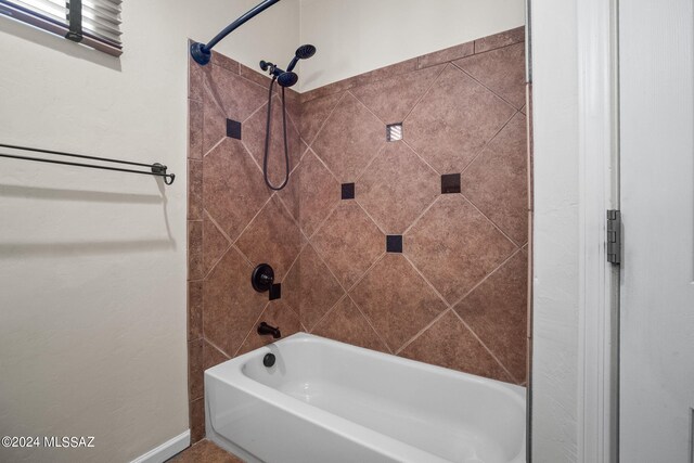 full bath featuring baseboards and tub / shower combination
