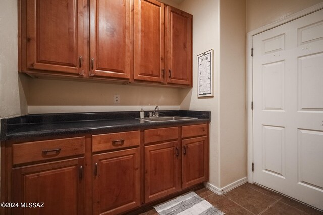 kitchen featuring brown cabinets and a sink
