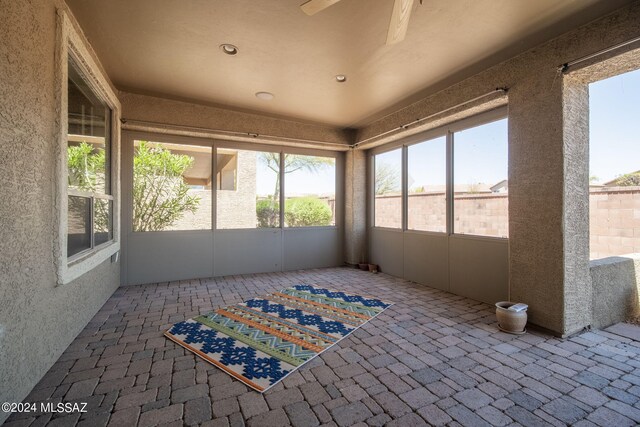 sunroom with ceiling fan and a healthy amount of sunlight