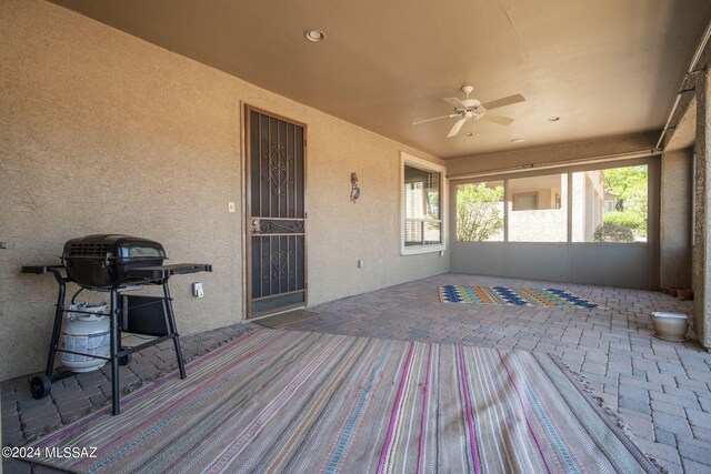 exterior space with a patio, a ceiling fan, and a grill