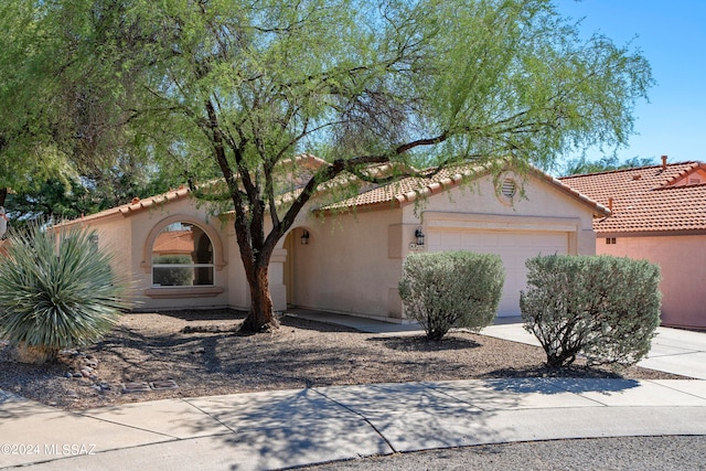 mediterranean / spanish-style house with a garage