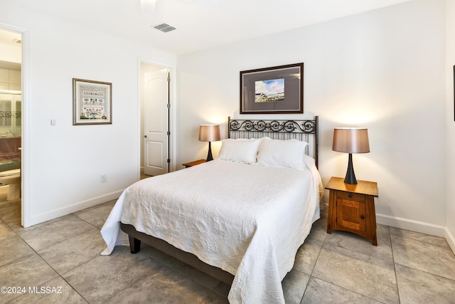 bedroom with visible vents, baseboards, ensuite bathroom, and tile patterned flooring