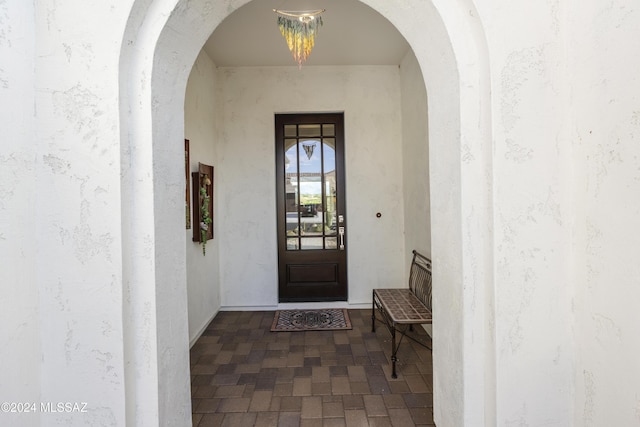 doorway to property featuring stucco siding