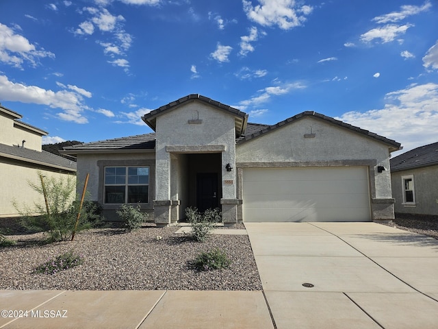 view of front of home featuring a mountain view and a garage