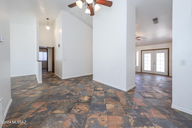 empty room with lofted ceiling, french doors, and ceiling fan