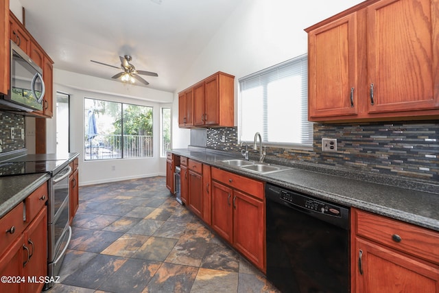 kitchen featuring lofted ceiling, ceiling fan, stainless steel appliances, sink, and backsplash