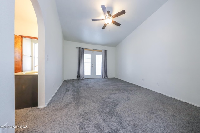 empty room with french doors, ceiling fan, vaulted ceiling, and carpet flooring