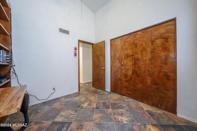 interior space with a closet and a high ceiling