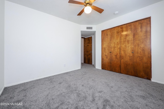 unfurnished bedroom featuring ceiling fan, carpet floors, and a closet