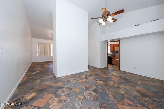 unfurnished living room featuring high vaulted ceiling and ceiling fan