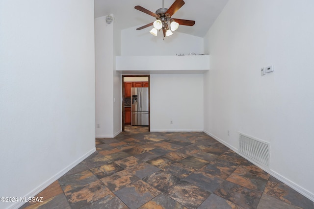 spare room featuring high vaulted ceiling and ceiling fan