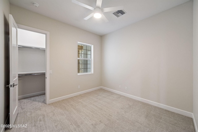 67970 E Madison Rd, Oracle, AZ 85623 - unfurnished bedroom featuring carpet flooring, a spacious closet, a closet, and a ceiling fan