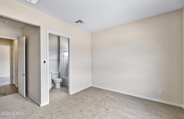 8257 S Silver Oak Dr, Tucson, AZ 85747 - unfurnished bedroom with carpet, baseboards, and connected bathroom