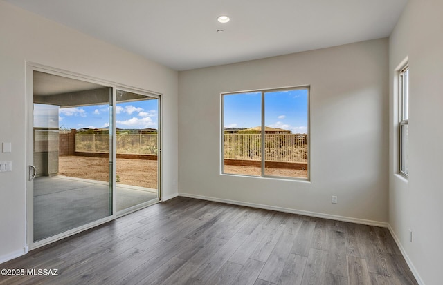 8257 S Silver Oak Dr, Tucson, AZ 85747 - unfurnished room featuring wood finished floors, baseboards, and recessed lighting
