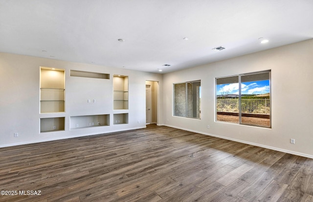 8257 S Silver Oak Dr, Tucson, AZ 85747 - unfurnished living room with dark wood-type flooring, baseboards, and built in shelves