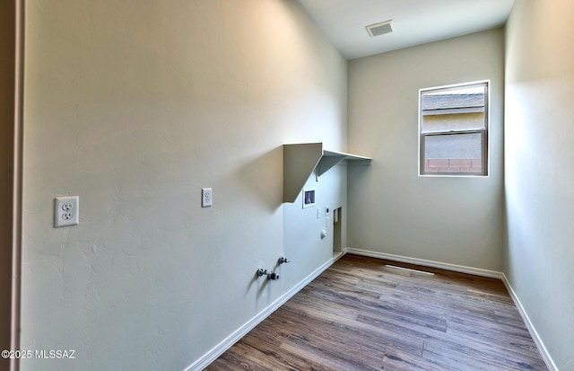 8257 S Silver Oak Dr, Tucson, AZ 85747 - laundry room with hookup for a gas dryer, electric dryer hookup, wood finished floors, and washer hookup