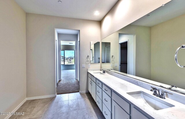 8257 S Silver Oak Dr, Tucson, AZ 85747 - bathroom with double vanity and baseboards