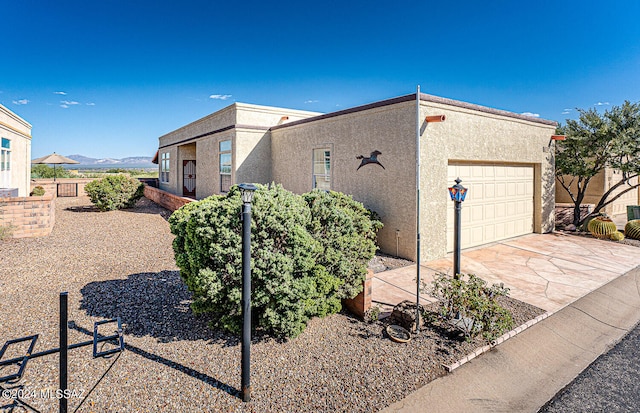 view of front facade featuring a garage and a mountain view