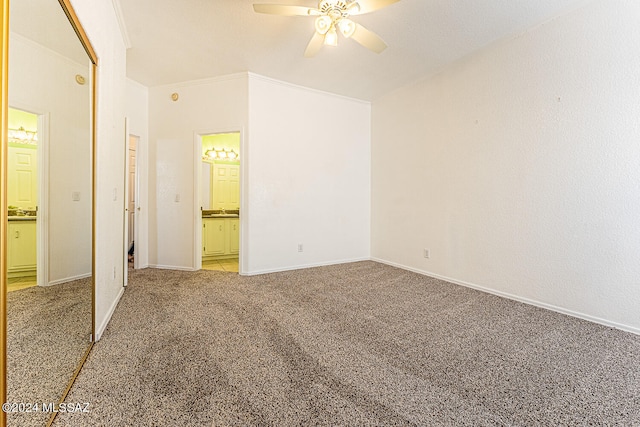 unfurnished bedroom featuring ornamental molding, light colored carpet, connected bathroom, and ceiling fan