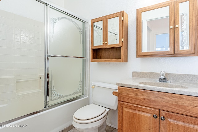 full bathroom with combined bath / shower with glass door, vanity, and toilet