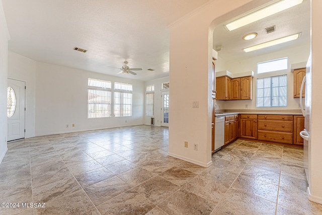 kitchen with white dishwasher, crown molding, ceiling fan, and a textured ceiling