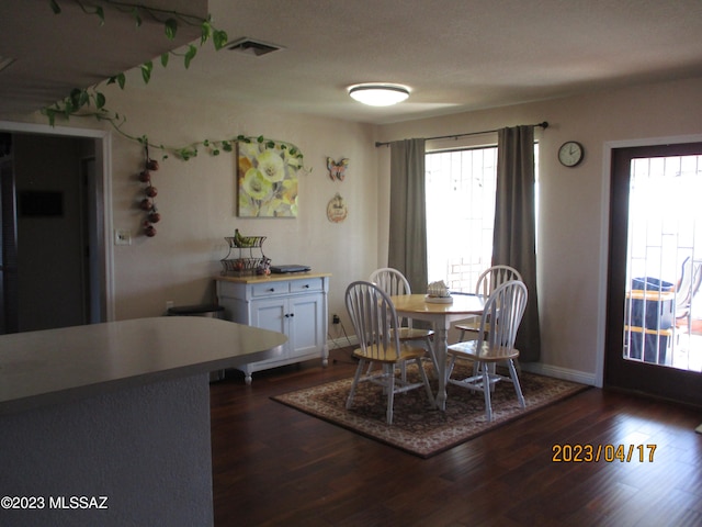 dining area featuring dark wood-type flooring