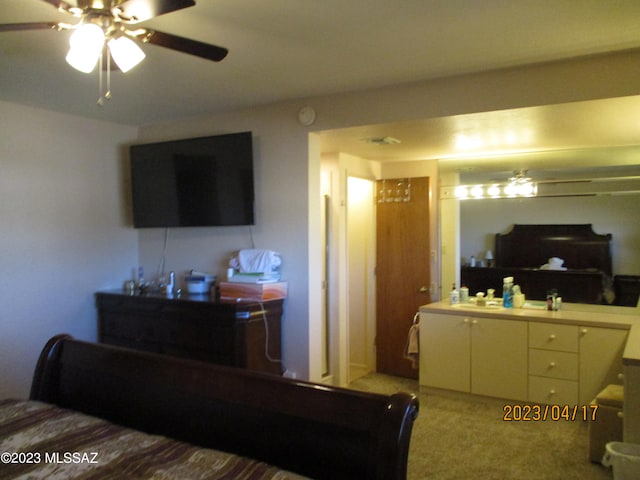 bedroom featuring ceiling fan, sink, and carpet