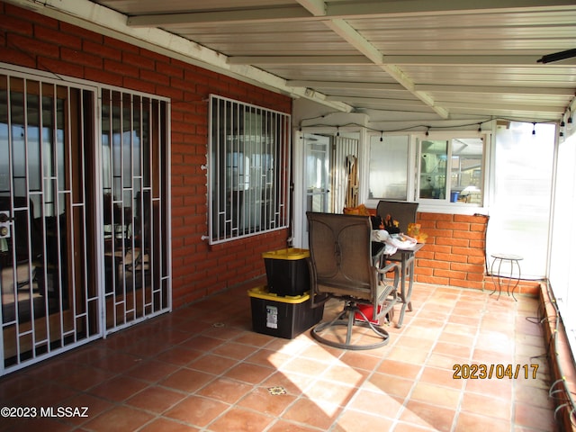 sunroom featuring beamed ceiling