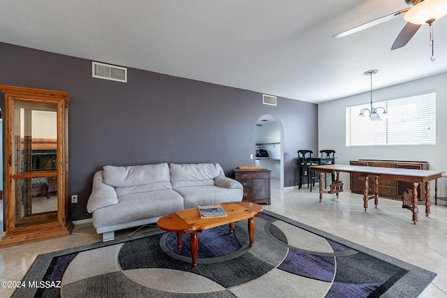 living room with ceiling fan and light tile patterned floors