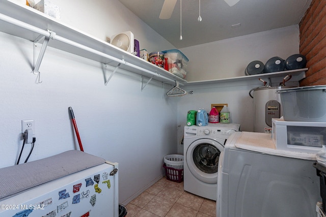 clothes washing area with light tile patterned floors, laundry area, separate washer and dryer, a ceiling fan, and water heater