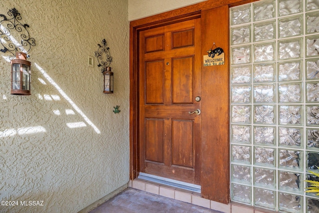 entrance to property featuring stucco siding