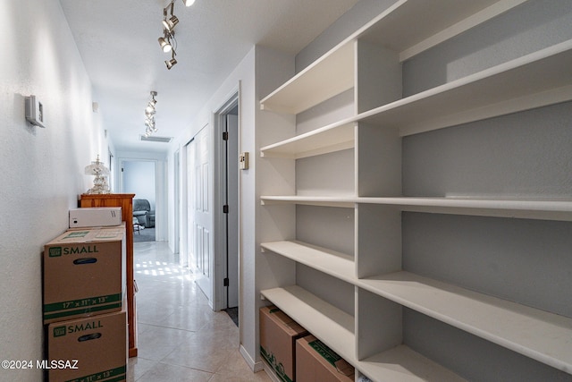 corridor with light tile patterned floors