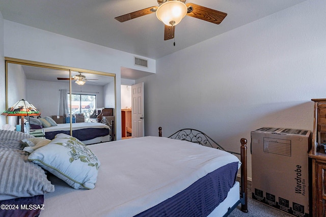 bedroom featuring a ceiling fan, a closet, visible vents, and carpet flooring