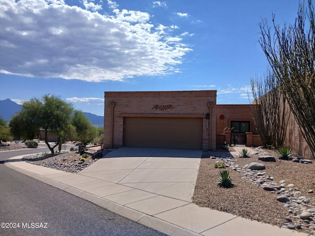 view of front of house with a mountain view and a garage