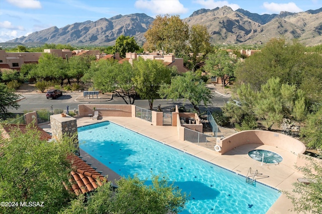 view of swimming pool featuring a mountain view and a patio area